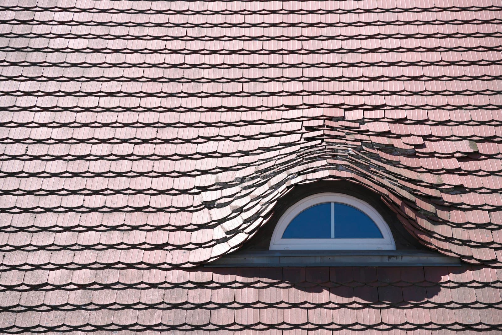 A dormer window set into a tiled roof