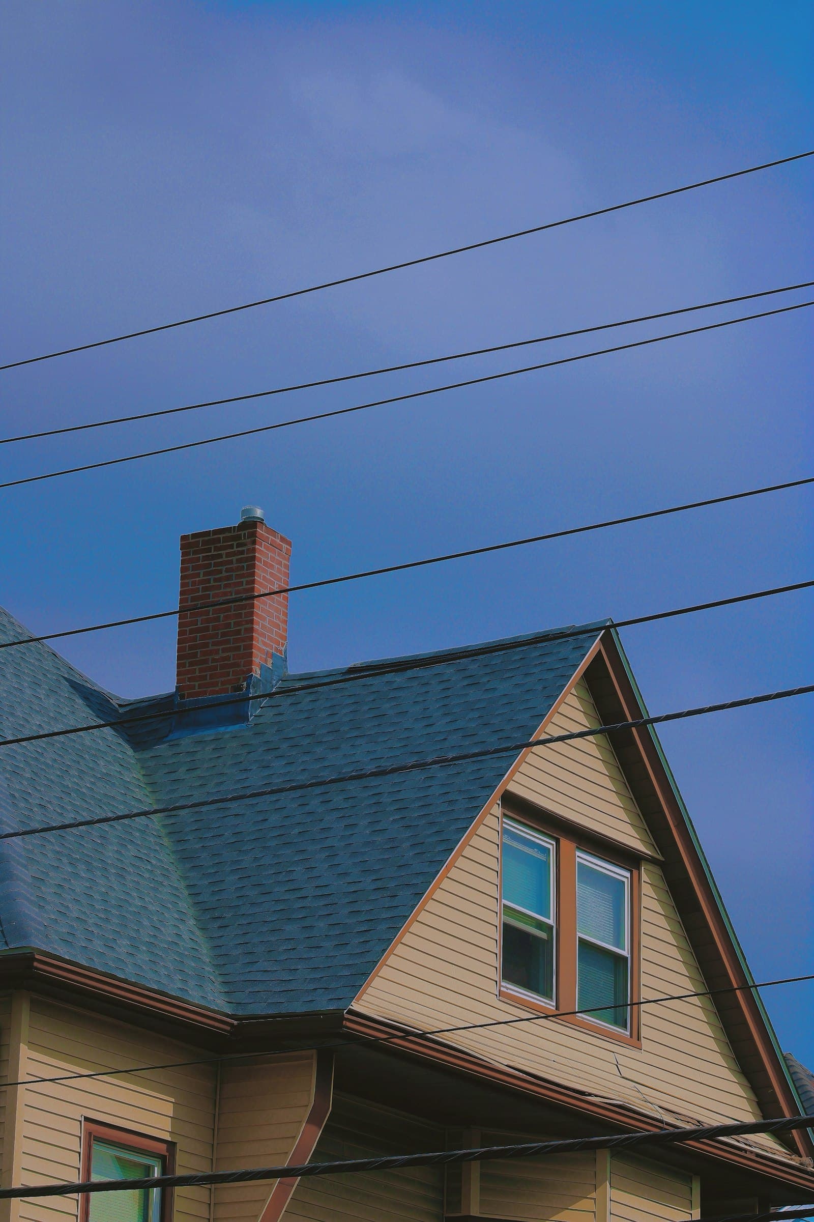 A house exterior with roof and chimney